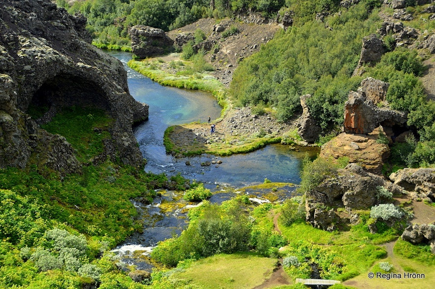 Gjarfoss waterfall is in the Gjain valley, a lush oasis with diverse natural features.