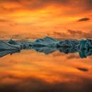 Visit Iceland during summer and see Jökulsárlón glacier lagoon bathed in the light of the midnight sun.