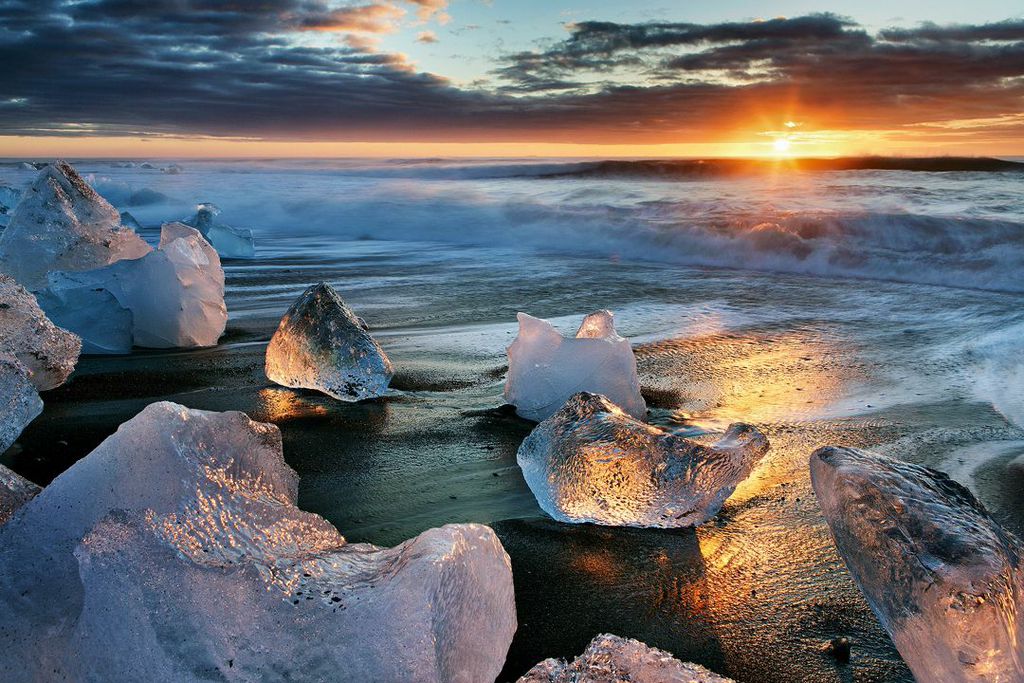 The midnight sun shines its gorgeous light upon the Diamond Beach in South Iceland.