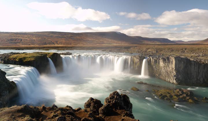 Goðafoss waterfall draped in autumn colours.