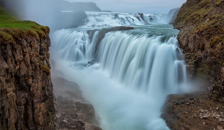 Water cascades down the majestic Gullfoss Waterfall, an attraction part of the Golden Circle Tour.