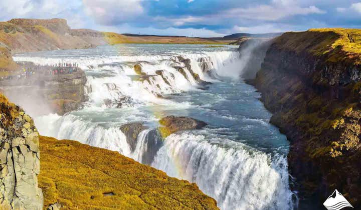 Gullfoss waterfall, one of Iceland's three Golden Circle attractions, looks spectacular with a rainbow in front on a sunny day.