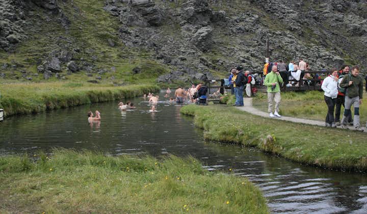 Travellers basking in the geothermal waters of Landmannalaugar.