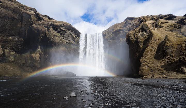 A rainbow formed by the sun and the spray from the mighty Skógafoss waterfall.