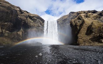 A rainbow formed by the sun and the spray from the mighty Skógafoss waterfall.