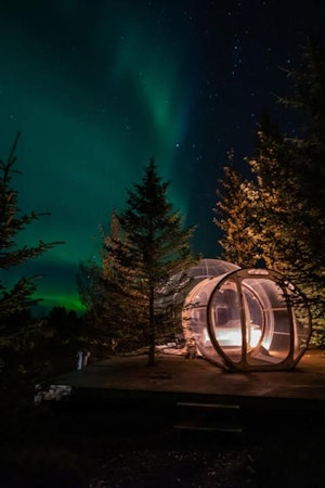 The northern lights can be seen from inside the bubble room at Buubble Hrosshagi during winter.