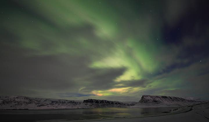 The Northern Lights mixing with a veil of soft clouds.