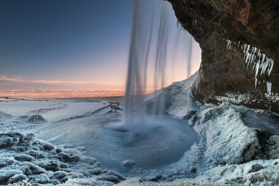A veiw from the inside of Seljalandsfoss Waterfall on Iceland's South Coast in winter.