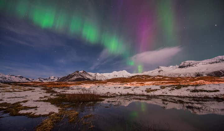 The northern lights dancing in the sky above Iceland in winter.