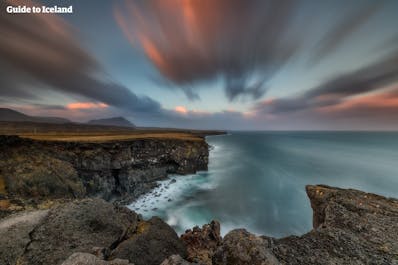 The Gerðuberg cliffs on the coastline of the Snæfellsnes Peninsula provide a dramatic and otherworldly scenery.