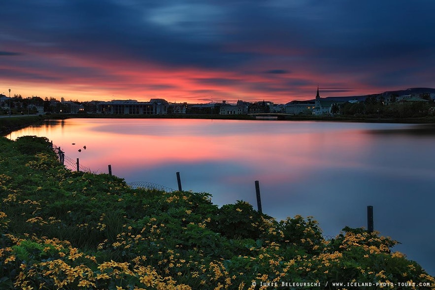 Romantic sunset view over Reykjavík's city pond