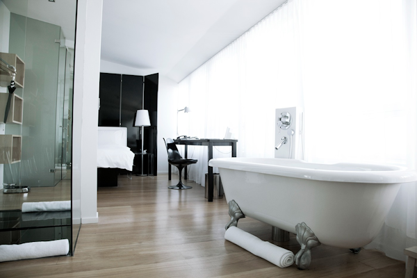 A spacious room with a large bed and bathtub at 101 Hotel Reykjavik in the city center.