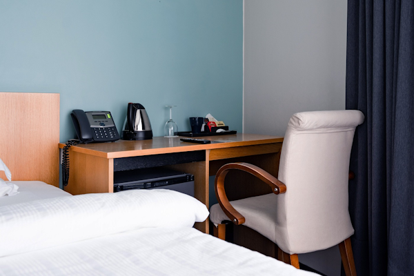 A desk area at Center Hotels Klopp, with tea and coffee making facilities and a telephone.