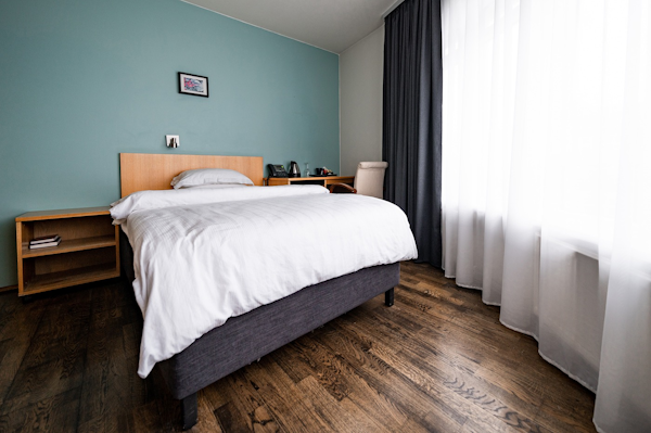 A hotel room in Center Hotels Klopp, Reykjavik, with a large double bed.