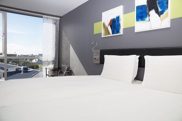 Stay in a light, modern room with large windows at Center Hotels Arnarhvoll.