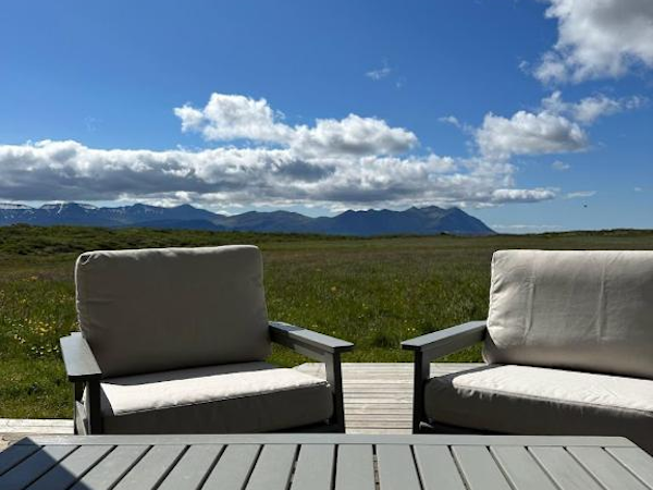 The outdoor seating area at Hestaland Horse Farm Cottage during summer in West Iceland.