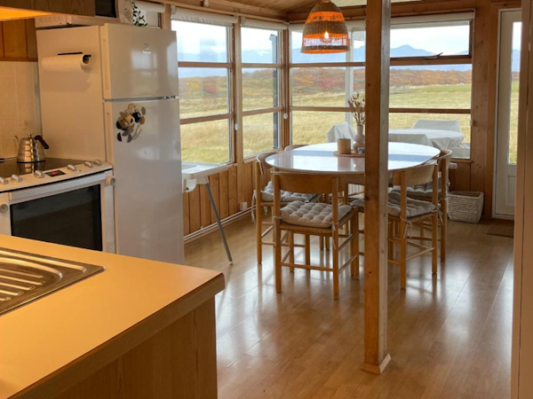 The dining area with fantastic views through the large windows in Hestaland Horse Farm Cottage.