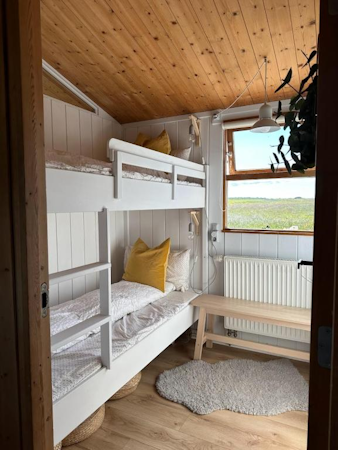 Two bunk beds in one of the bedrooms at Hestaland Horse Farm Cottage.