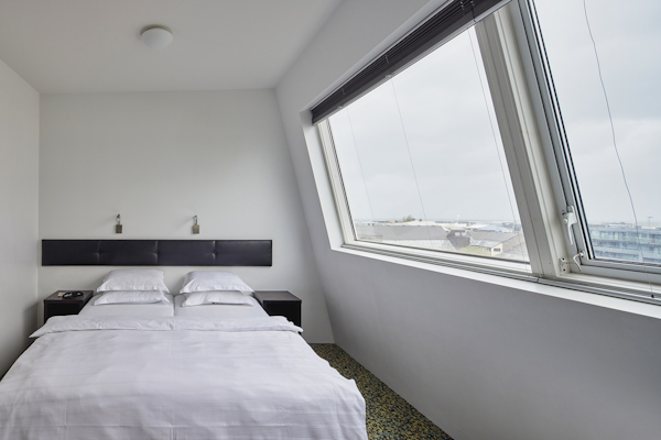 A modern, white hotel room in Reykjavik.