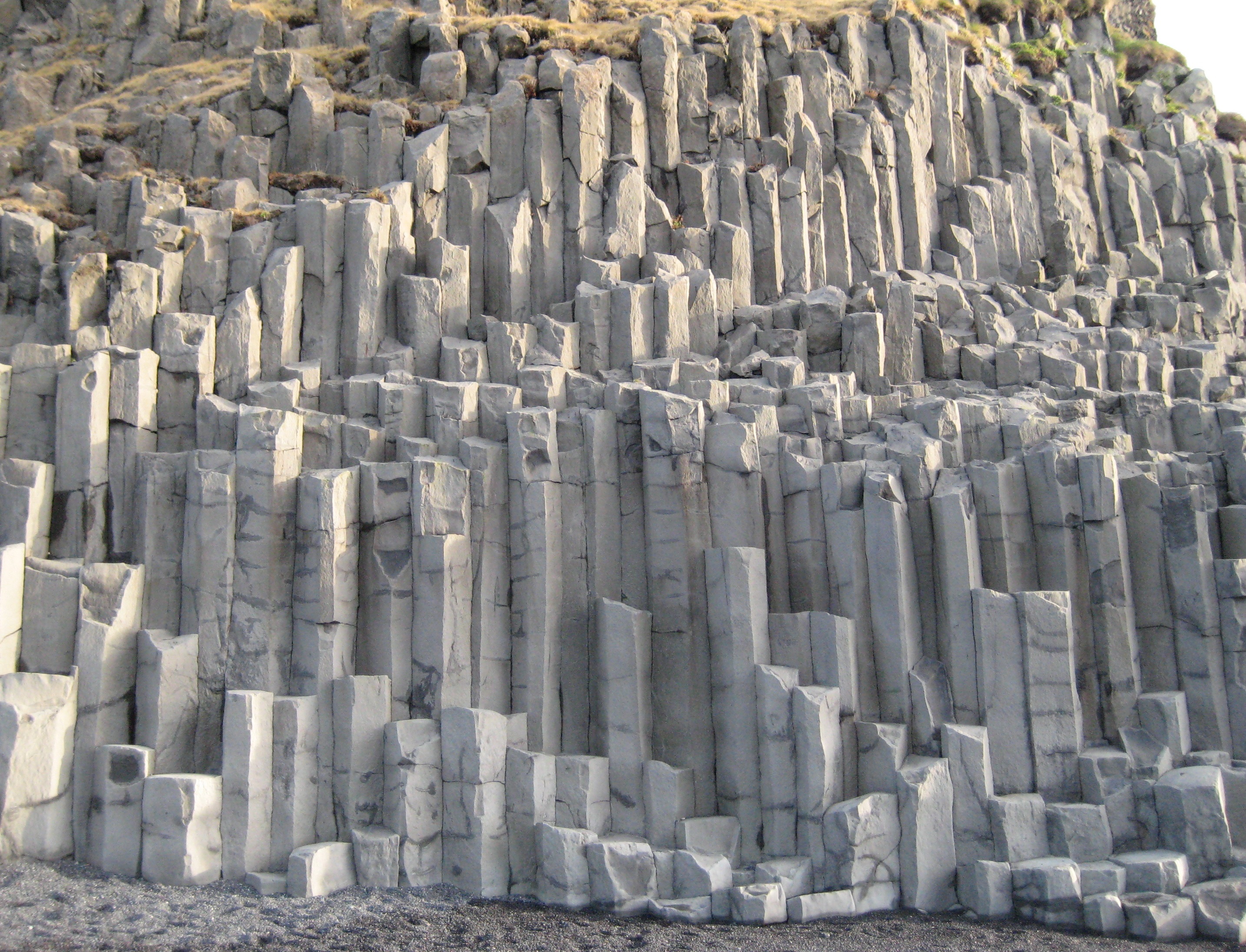 Hexagonal basalt columns can be found on Iceland's South Coast, particularly around the cliffs and arch of Dyrhólaey.