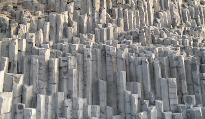 Hexagonal basalt columns can be found on Iceland's South Coast, particularly around the cliffs and arch of Dyrhólaey.