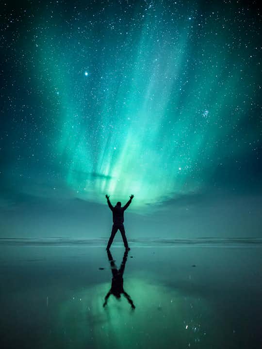 northern lights aurora borealis iceland stokksnes silhouette person stars night.jpg
