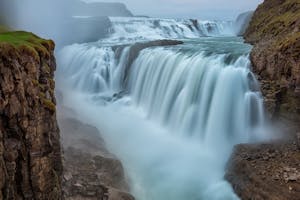 Long-exposure photo of Gullfoss waterfall on a cloudy day