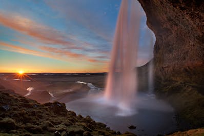 South Iceland's Seljalandsfoss is a unique waterfall with a pathway which leads behind the falling water.