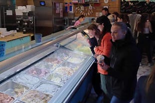 A group of travelers sampling different flavors of ice cream in Reykjavik.