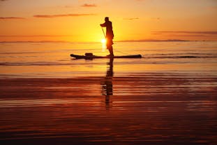 Stand-up paddleboarding is great fun at sunset.