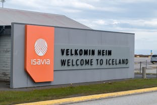 A sign at Keflavik International Airport saying 'Welcome to Iceland' in Icelandic and English.