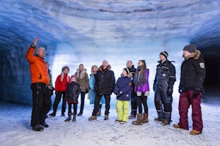 A group of tourists is touring inside the Langjokull ice cave.