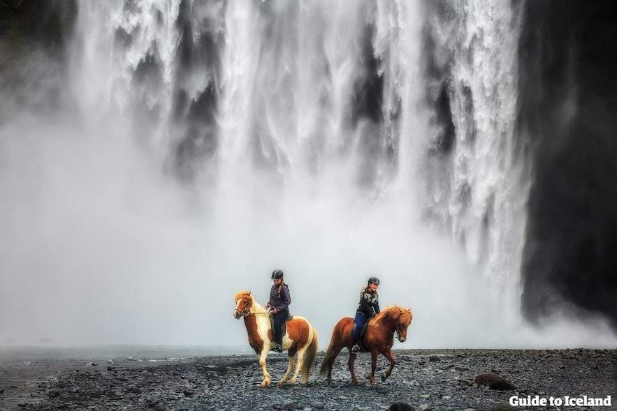 Horse riding by Skógafoss waterfall