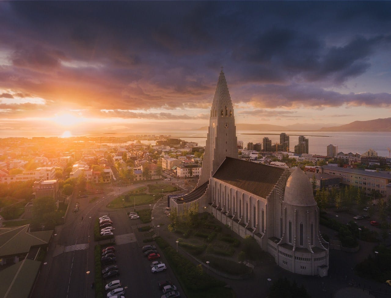 An aerial view of Reykjavík reveals the beauty of the city under the midnight sun.