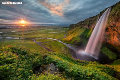 You can walk behind Seljalandsfoss waterfall and enjoy the view of South Iceland from behind the cascading wall of pristine water.