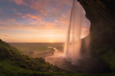 Behind the waterfall Seljalandsfoss, one of the most popular features along the South Coast, is a wide cavern that allows visitors to fully encircle it.