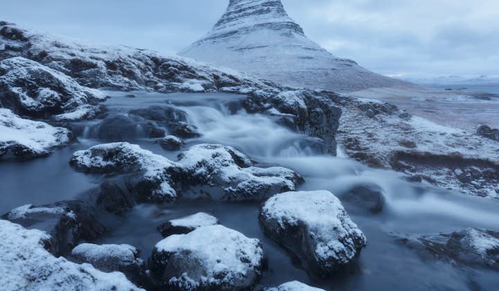 Mt. Kirkjufell, standing by the Snæfellsnes peninsula, takes on a striking look covered with snow during the Icelandic winter.