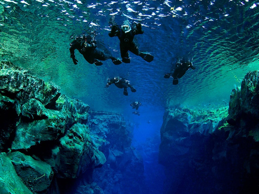 Snorkellers floating over 'The Cathedral' in Silfra Fissure.