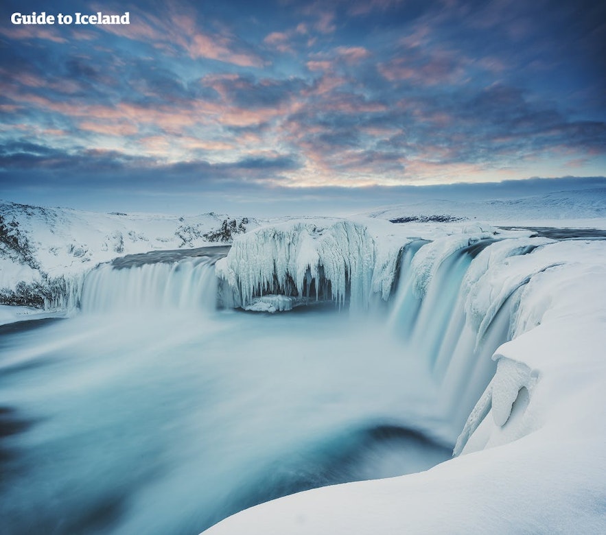 Godafoss in winter, wrapped in snow. One of the best things to do in Iceland in February.