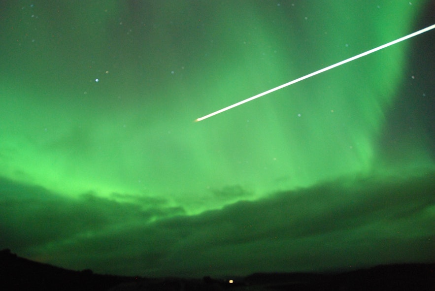 Meteor flying through the auroras in North Iceland