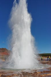 The geyser Strokkur spouting hot water high in the air