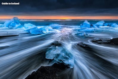 The Diamond Beach is a site of contrasts in South Iceland, where the black sands, blue ice and white surf form a stunning composition.