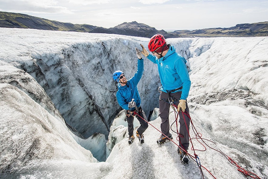 With hats under their helmets, gloves, wind- and waterproof outer layers and sturdy hiking shoes, these two ice climbers are excellent examples of how to dress to prepare for Iceland.