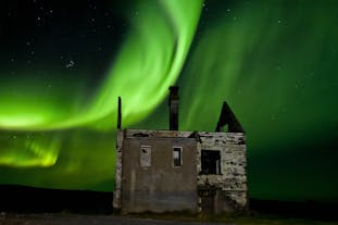 The Northern Lights over an abandoned building.