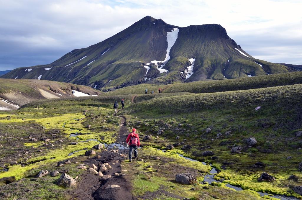Hikers in front of the distinctive mountain Brattháls in the Highlands of Iceland.