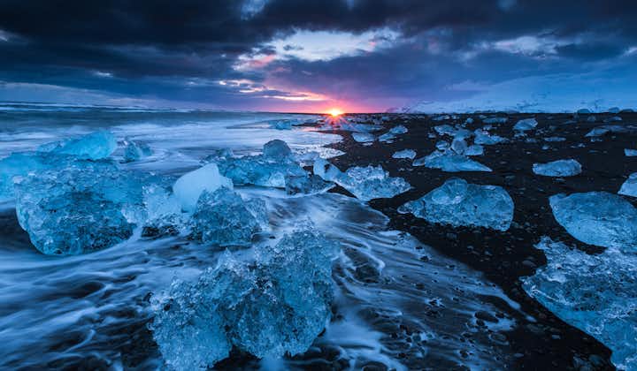 On a winter self-drive tour, you can visit the Diamond beach in the evening and watch as the sun sets among glistening icebergs.