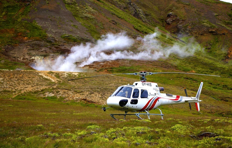 A helicopter making a landing at one of Iceland's geothermal valleys.