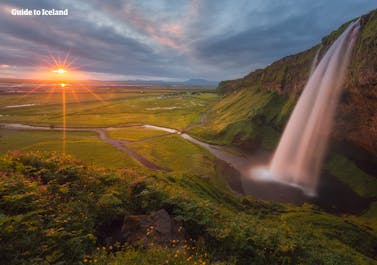 Seljalandsfoss Waterfall, found on Iceland's picturesque South Coast, has a path encircling it.