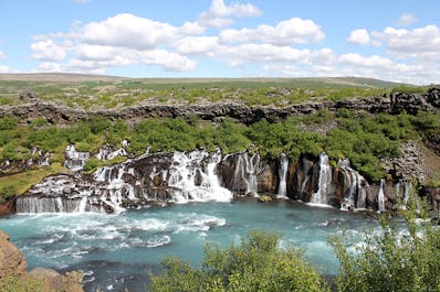 Hraunfossar is a series of gorgeous waterfalls that seem to spill straight out of the lava rock lining the banks of the Hvita river.