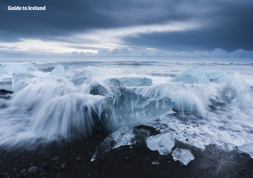 The Atlantic Ocean washes over icebergs on Diamond Beach, on the South Coast of Iceland.